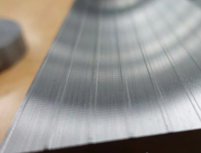 The surface of the workpiece shows ripples caused by vibration.
